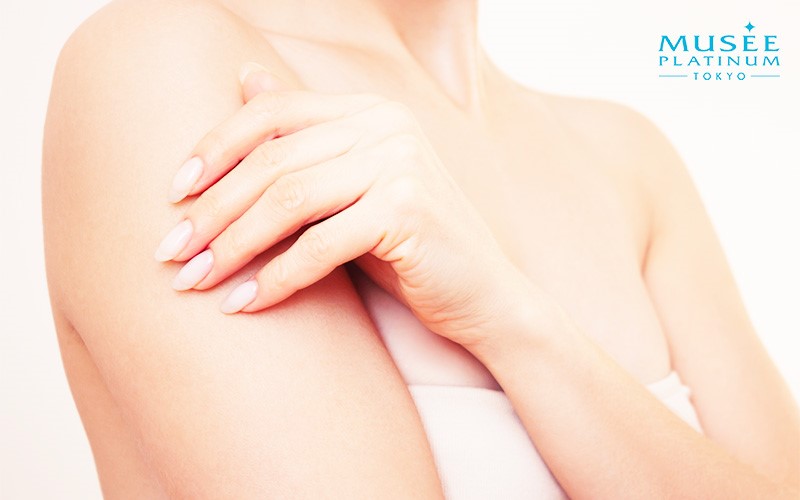 Woman holding her upper arm after hair removal